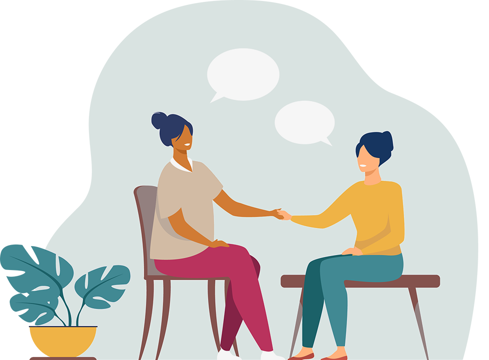Two ladies seated, shaking hand during a chat